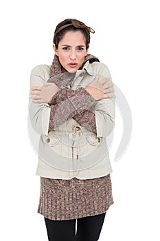 Freezing cute brunette in winter fashion looking at camera