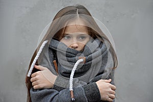 Freezing girl snuggles in her woolen sweater