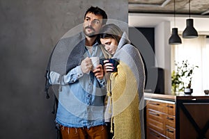 Freezing man and woman suffering from cold or flu fever or having trouble with central heating
