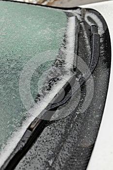 Freezing Rain Creates a Layer of Ice and Coats a Passenger Vehicle. Close up of Windshield