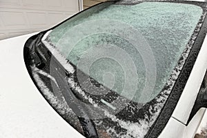 Freezing Rain Creates a Layer of Ice and Coats a Passenger Vehicle. Close up of Windshield