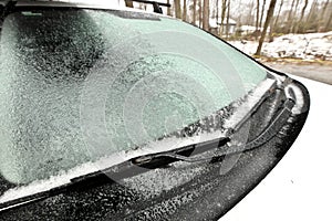 Freezing Rain Creates a Layer of Ice and Coats a Passenger Vehicle. Close up of Windshield