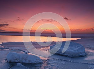 Freezing sea shore in the romantic evening light