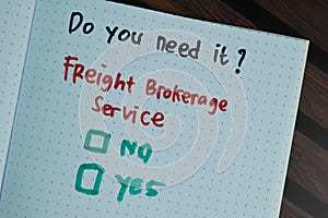 Freight Brokerage Service write on a book and supported by additional services write on a sticky notes isolated on Wooden Table