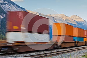 Freight cargo train passing mountains