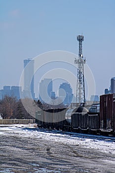 Freight Cars Sit Idle At The Toronto Shipping Yards With Skyscrapers In The Background