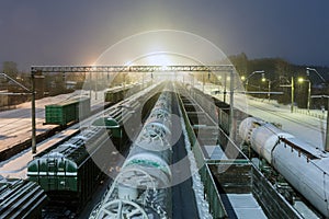 Freight cars on the sorting cargo station in the light of searchlights