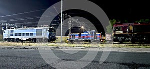 Freight locomotives on a siding at night photo