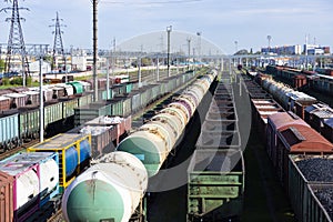 Freight railway cars at the railway station. Top view of cargo trains.Wagons with goods on railroad. Heavy industry. Industrial