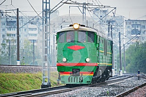 Freight retro diesel locomotive under the rain