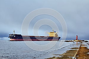 Freight ship on windy day in autumn going from port to the Baltic sea