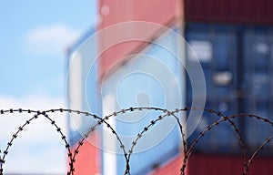 Freight shipping containers behind barbed wire