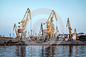 In freight terminal, gantry crane and cargo ships are in loading and unloading of goods