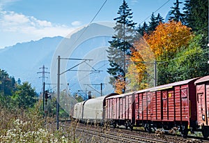 Freight train in autumn landscape