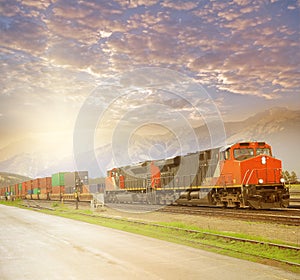 Freight train in Canadian rockies at sunset.