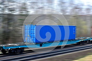 Freight train with cargo containers on railway with motion blur effect