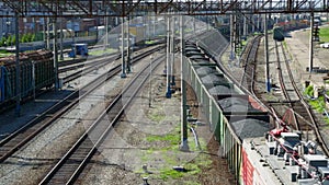 Freight train with coal moving on train station