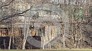 Freight train crosses a bridge in small town USA