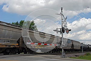 Freight train at crossing gate