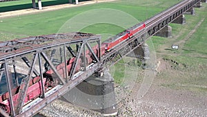 Freight Train Crossing an Iron Bridge Spanning a River