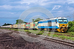 Freight train by diesel locomotive on the railway.