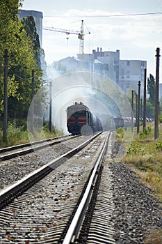 The freight train is driven by a diesel locomotive. railroad in the city