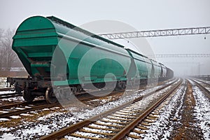 Freight train with hopper cars in the fog