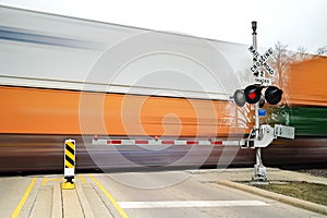 freight train in motion at crossing gate