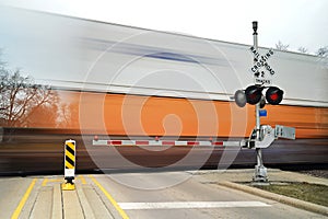 freight train in motion at crossing gate