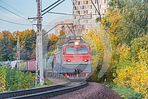 Freight train moves at autumn evening.