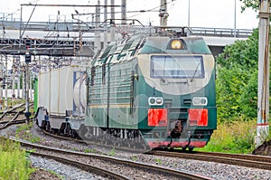 The freight train passes by the station. Wagons with goods delivery