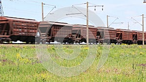 Freight train passing through the field at noon