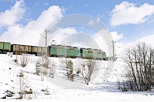 Freight train passing by railways in winter