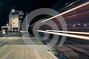 A freight train passing through the train station at night