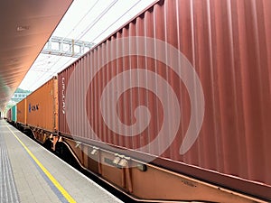 Freight train passing through train station.