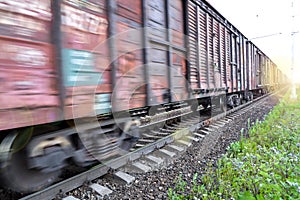 Freight train, railway wagons with motion blur effect. Transportation, railroad.