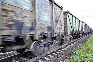 Freight train, railway wagons with motion blur effect. Transportation, railroad. photo