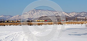 Freight train rides on a background of mountains