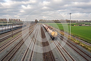 Freight train with tank wagons at a Dutch train station