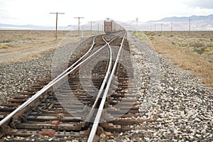 Freight train on tracks crossing desert, NV, US