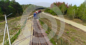 Freight train transports containers view from the drone, transportation of cargo by train, transportation of containers