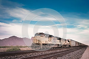 Freight train traveling Arizona desert.