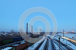 Freight trains with carriages stand on railways