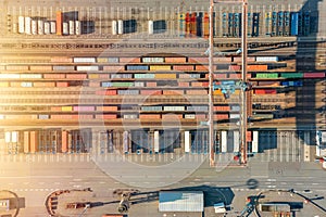 Freight trains from containers at a container terminal. Aerial view of container terminal with containers and container bridge.