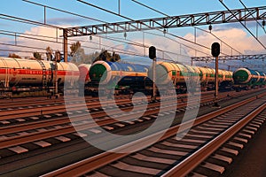 Freight trains with fuel tank cars in sunset