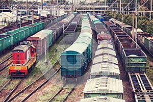 Freight trains and locomotive at a station in a railway depot