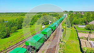Freight wagons train arrive at a ferry station near the bridge rail tracks railroad. Aerial view heavy industry landscape