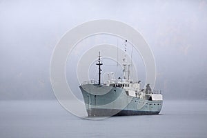Freighter at Anchor in Fog