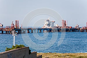 Freighter loading or unloading at a wharf photo