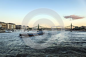 Freighter Riverboat Sails Under the Liberty Bridge in Budapest, Hungary